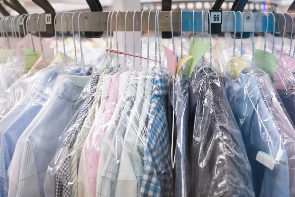 Freshly dry-cleaned shirts in garment bags on the rack