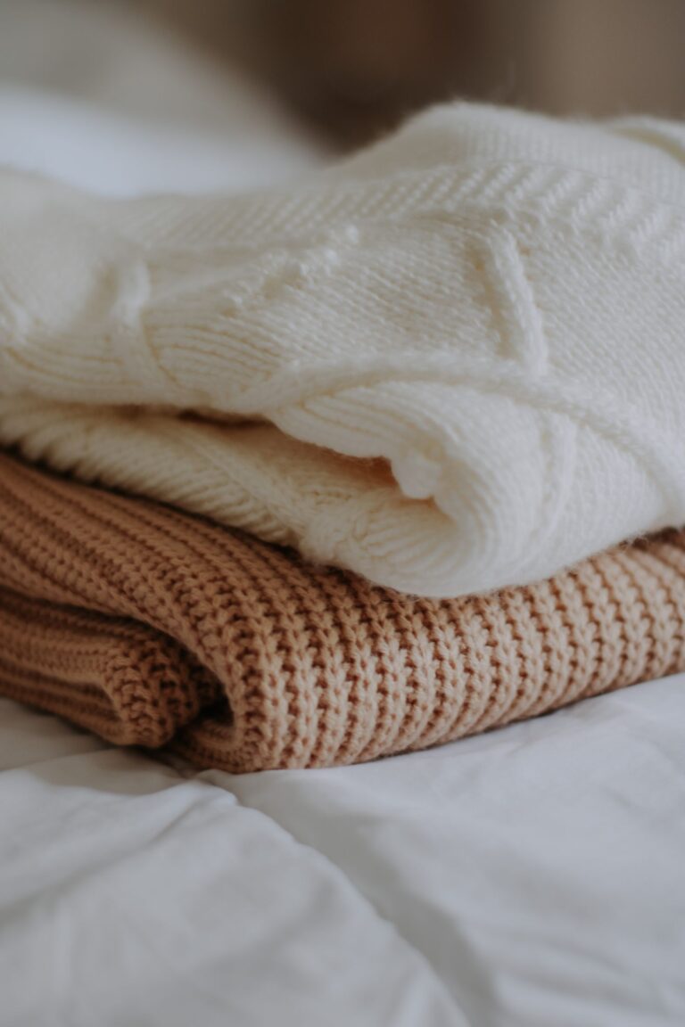 A stack of neatly folded knit sweaters