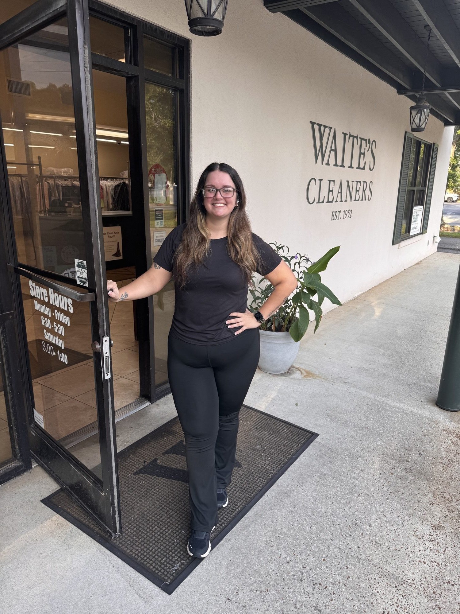 A Waite's Cleaners team member at the entrance of the Old Shell Rd store in Mobile, AL